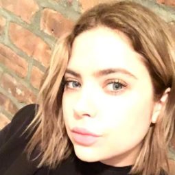 close up shot of ashley benson with bronde hair colour and short bob haircut, wearing all black