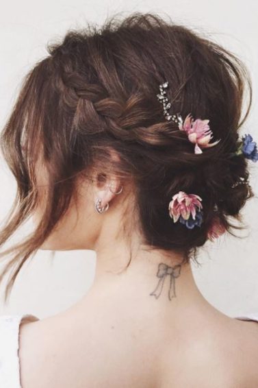 Short hair wedding updos - brunette hair with braids and flowers places throughout. Loose front section framing face
