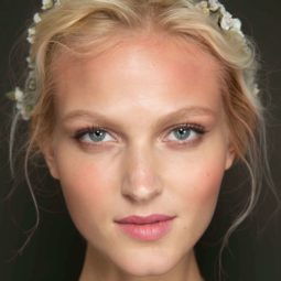 Wedding hairstyles for short hair: Woman withbaby bonde wavy hair in updo with floral headband.
